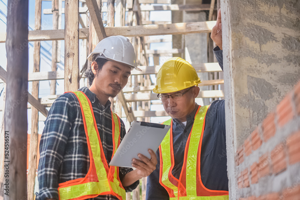 Team engineer Two man architect on a building construction site Team engineer Two man architect on a building construction site