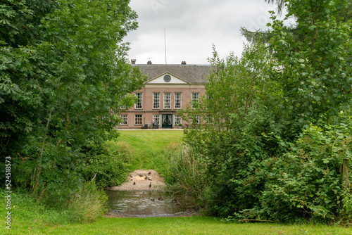 Main house at Landgoed Heerlijkheid Mariënwaerdt in The Netherlands, with water in front. photo