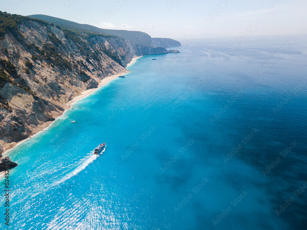 aerial view of small cruise boat sailing around Lefkada island