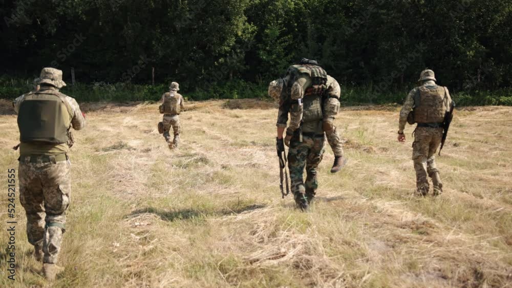 The soldier carries the wounded warrior on his shoulders, an injured man is evacuated from battlefield, a special unit covers a wounded soldier's weapon from enemy fire The soldier carries the wounded warrior on his shoulders, an injured man is evacuated from battlefield, a special unit covers a wounded soldier's weapon from enemy fire