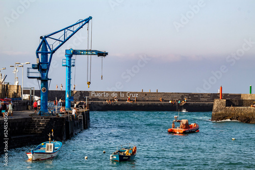 Puerto pesquero de tenerife, gruas y pequeñas embarcaciones pesqueras. photo