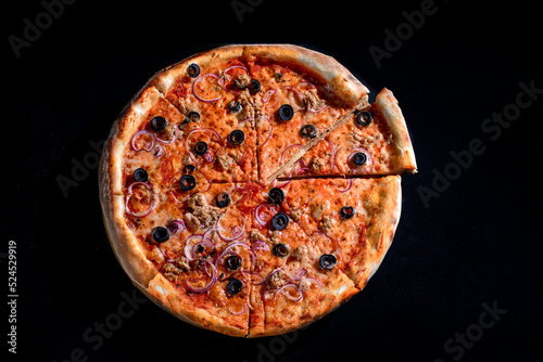 Pizza with tuna, olives, onions, mozzarella cheese and tomato sauce on a black background. Top view