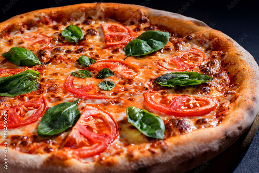 Delicious fragrant pizza with mozzarella, tomatoes and basil with tomato sauce - Margherita