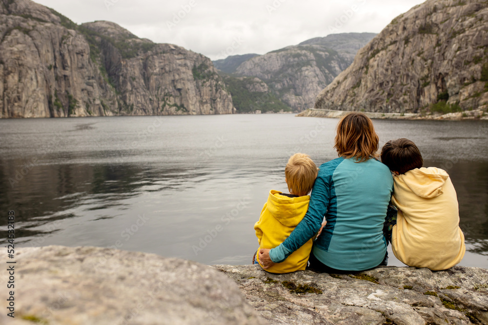 Family, children, adults and dog, enjoying the beach in Forsand, Lysebotn on a cloudy day