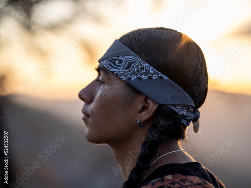 Side profile of a young native man wearing a bandana 
