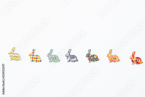 Wooden figures in the form of rabbits on a white background. Easter concept © ALEXSTUDIO