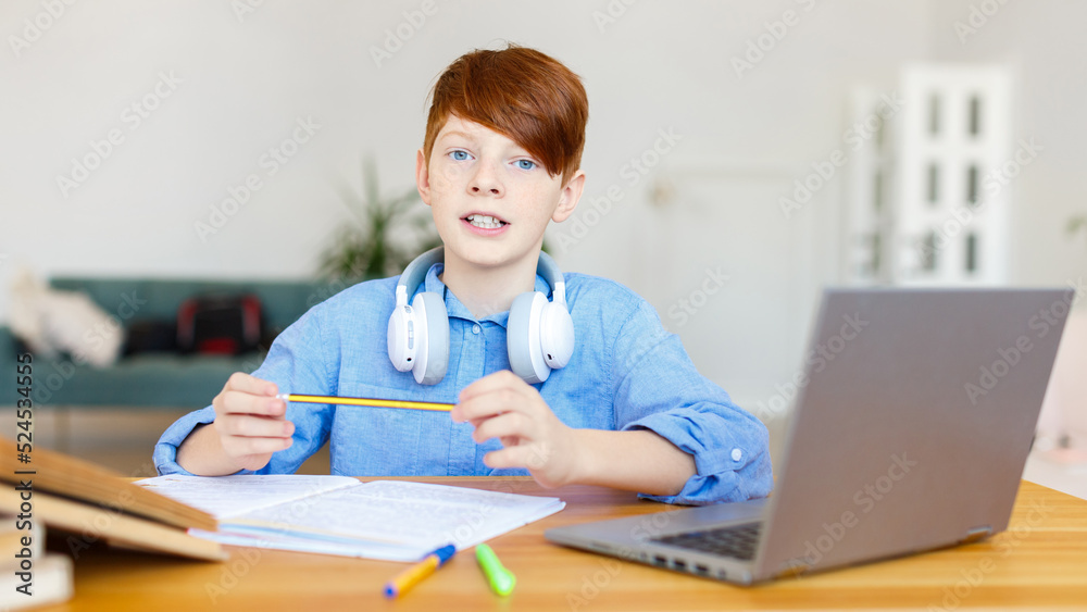 Schoolboy during an online seminar. He makes a presentation on his topic. Format photo 16x9. Schoolboy during an online seminar. He makes a presentation on his topic. Format photo 16x9.
