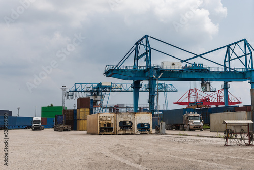 Container vessel during loading at an industrial port by port crane.Container ship import export global business commercial trade logistic and transportation oversea worldwide by container cargo