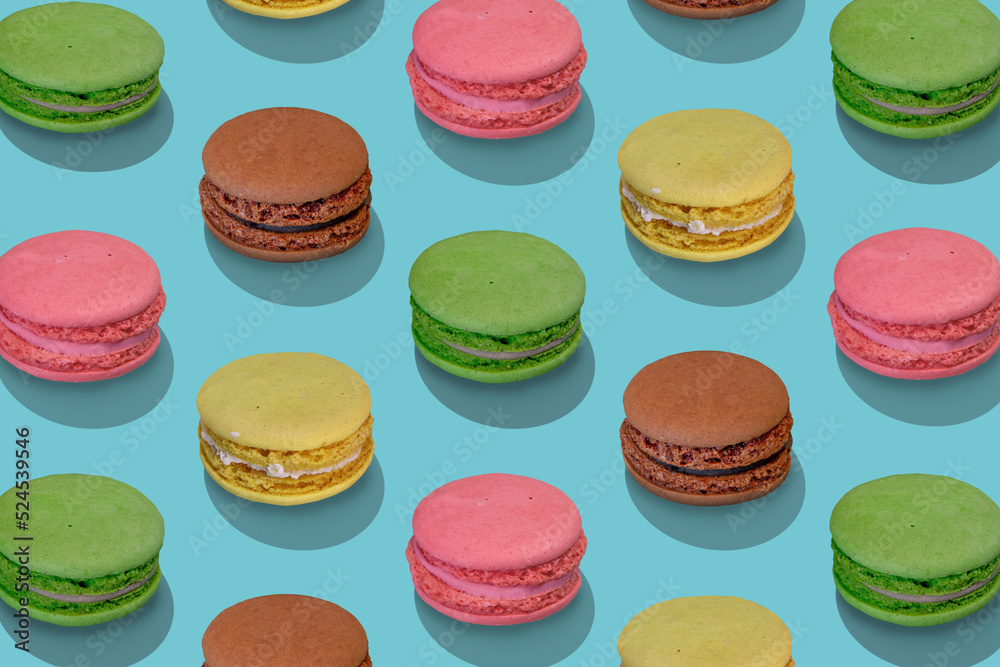 Beautiful composition from large group of french macarons on blue background. Flat lay, top view. Isometric view.