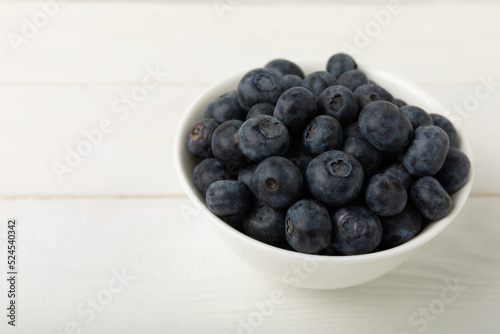 Blueberries in a bowl on white textured background. Ripe and fresh blueberries. Vitamins. Healthy food. Juicy berry.Copy space.Place for text