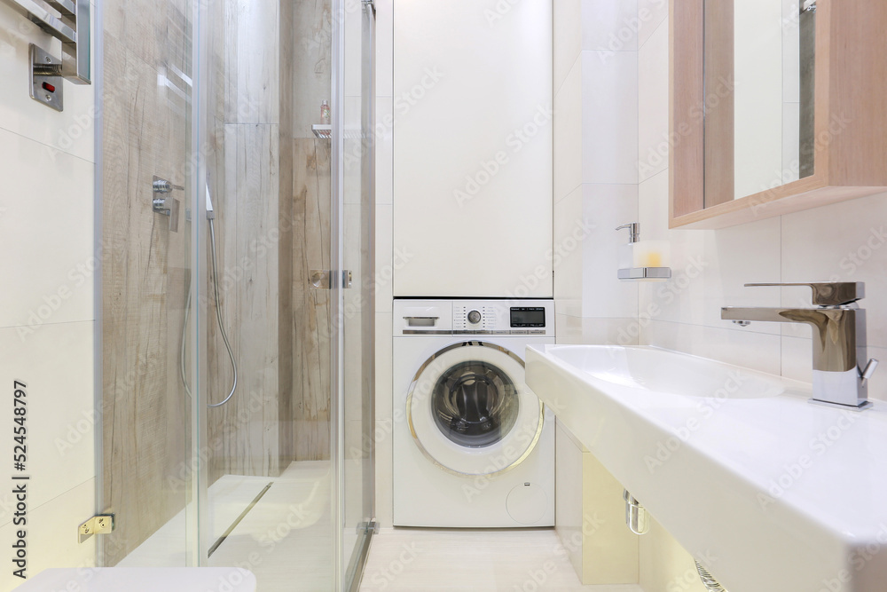 Washing machine in a modern bathroom interior Washing machine in a modern bathroom interior
