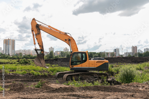 Crawler excavator digs the earth with a bucket. Drainage of swamps. Peat mining. Excavators are used when working in quarries and mine workings.