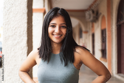 Portrait of a young latin american woman looking at camera. Free Download Portrait of a young latin american woman looking at camera. - GFXLoad