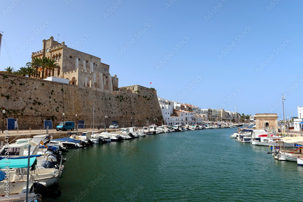 Ciutadella, Menorca (Minorca), Spain. Ciutatella marina (Puerto de Ciutadella) with boats and yachts and Town Hall building view. Sunny day in the marina of Ciutedella