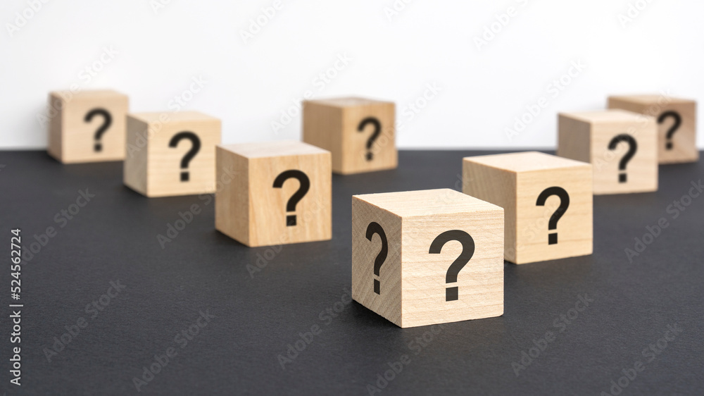 front view on many wood cubes with question marks. many question arising concept front view on many wood cubes with question marks. many question arising concept