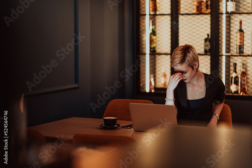 Businesswomen are stressed while working on laptop, Tired businesswoman with headache in coffee shop , feeling sick at work. Selective focus 