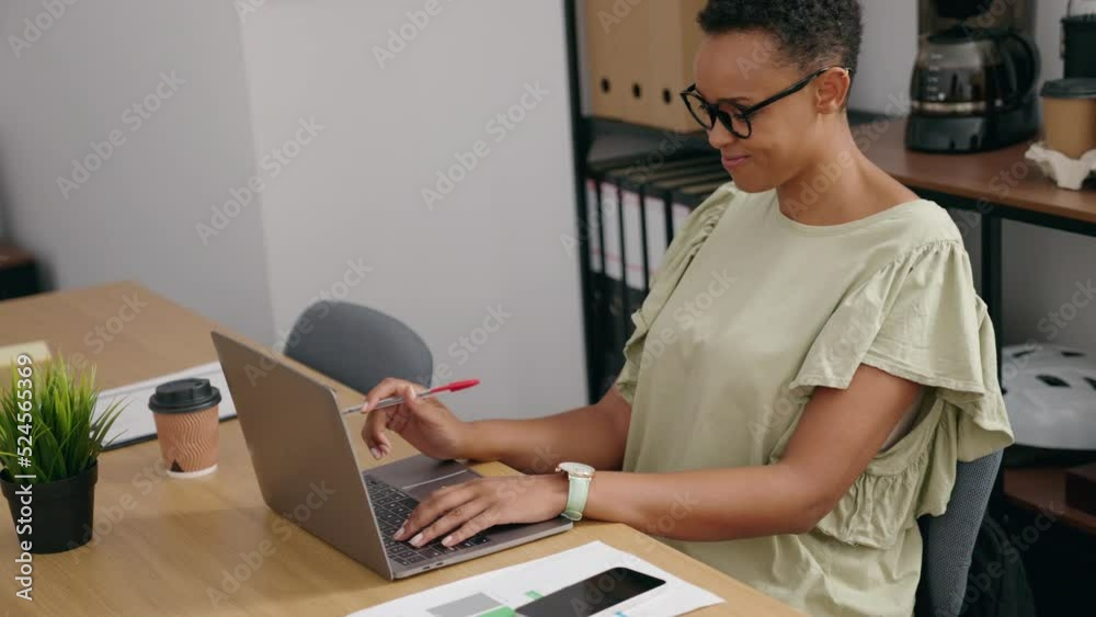 African american woman business worker using laptop relaxed with hands on head at office