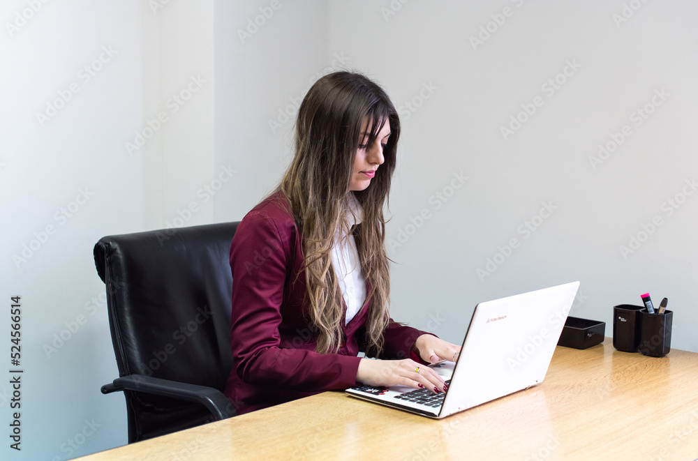 Portrait of a woman working on her laptop in the office. Portrait of a woman working on her laptop in the office.