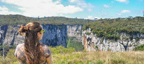 A young woman looking at the stunning Itaimbezinho Canyon in Cambará do Sul, Rio Grande do Sul, Brazil photo