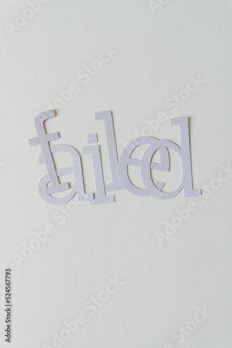 the word "failed" on blank paper