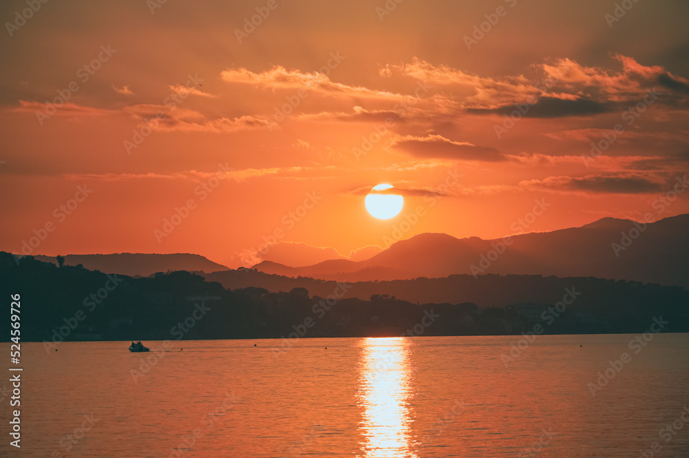 scenic sunset over mountains and ocean in Saint-Tropez, France.
