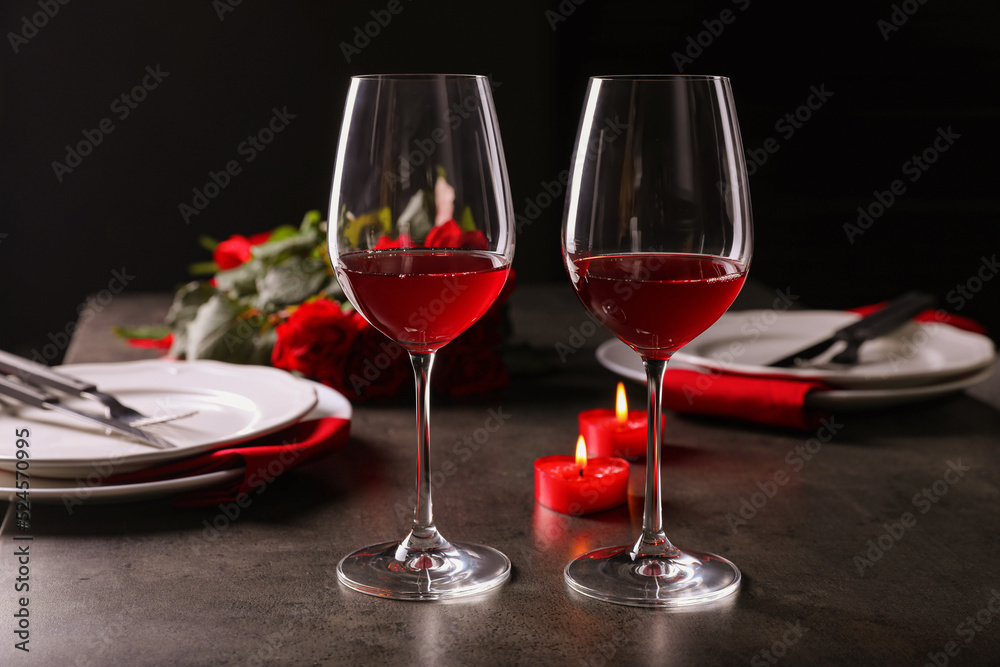 Beautiful place setting for romantic dinner on grey table