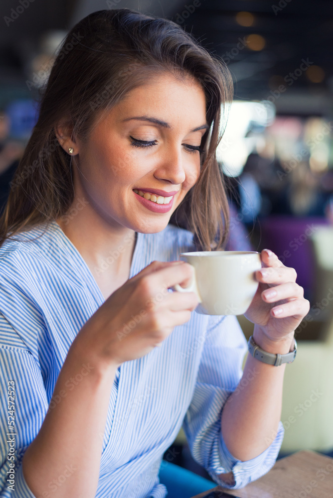Young woman drinking coffee in the coffee shop Young woman drinking coffee in the coffee shop