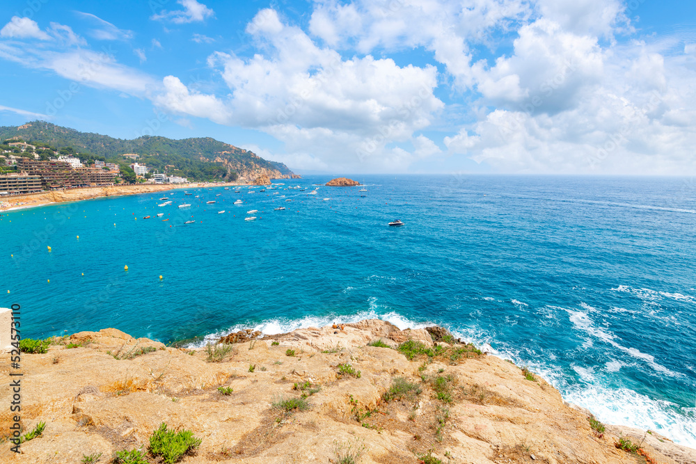 View from the hilltop castle of the Mediterranean sea along the sandy beach and town in the Costa Brava town of Tossa de Mar, Spain.