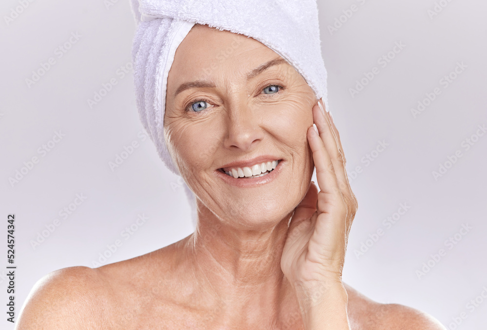 Portrait of happy woman wear a towel on head after enjoying a refreshing shower and healthy skincare. Senior beauty, cosmetic and face model smile while posing against a grey copy space background Portrait of happy woman wear a towel on head after enjoying a refreshing shower and healthy skincare. Senior beauty, cosmetic and face model smile while posing against a grey copy space background