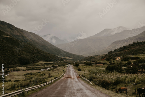 road leading to misty cloudy mountains in lesotho africa