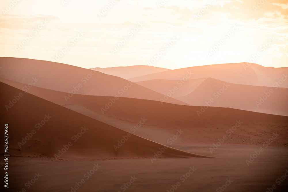 dramatic sunset over sand dunes in namibia