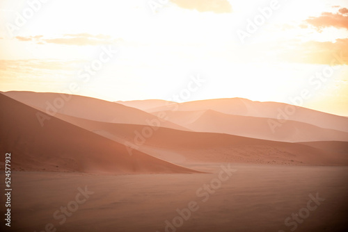 dramatic sunset over sand dunes in namibia