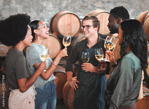 Photography Group of friends wine tasting at a distillery or cellar drinking glasses and enjoying the tour together