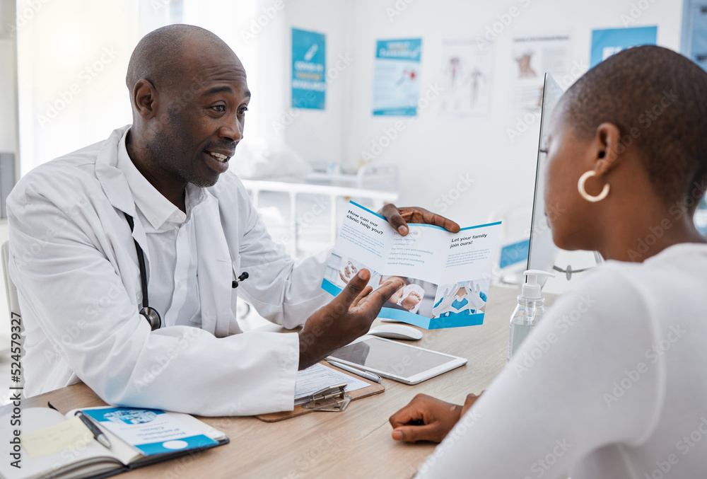 A doctor giving patient hospital information at a clinic and explaining medical benefits to a woman in his office. African American GP or healthcare professional having a discussion with a female A doctor giving patient hospital information at a clinic and explaining medical benefits to a woman in his office. African American GP or healthcare professional having a discussion with a female