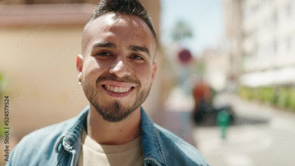 Young hispanic man smiling confident standing at street Young hispanic man smiling confident standing at street