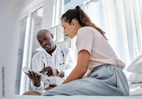 Schilderij op canvas Doctor appointment or healthcare professional consulting a patient and showing her online medical results on a tablet