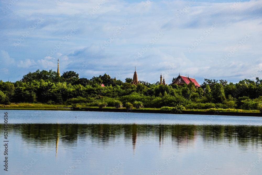 Water, shadows of Thai temples, forest and sky, background