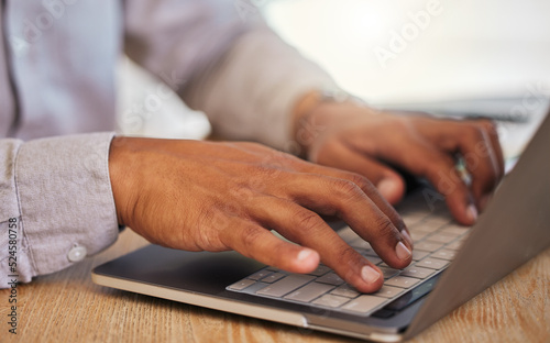 Closeup of a businessmans hands typing on laptop at work in corporate, creative and modern office. Professional male leader browsing the internet or coding on an innovative computer network.