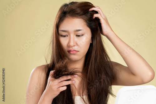 Ardent young girl feels insecure about her damaged hair. Beauty concept of brittle hair and how to treat it.