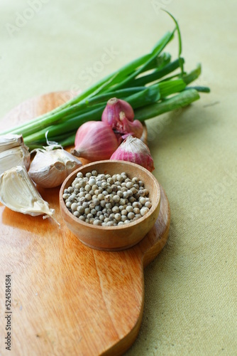 selective focus of pepper in a wooden bowl