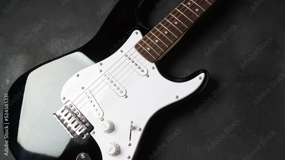 Naklejka premium Front of electric guitar body on dark background.
