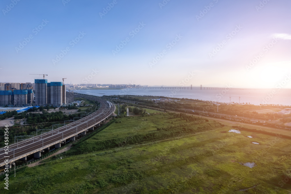 High-speed train passes through railway bridge in modern Chinese city High-speed train passes through railway bridge in modern Chinese city