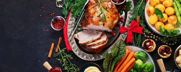 Traditional Christmas dinner on dark background.