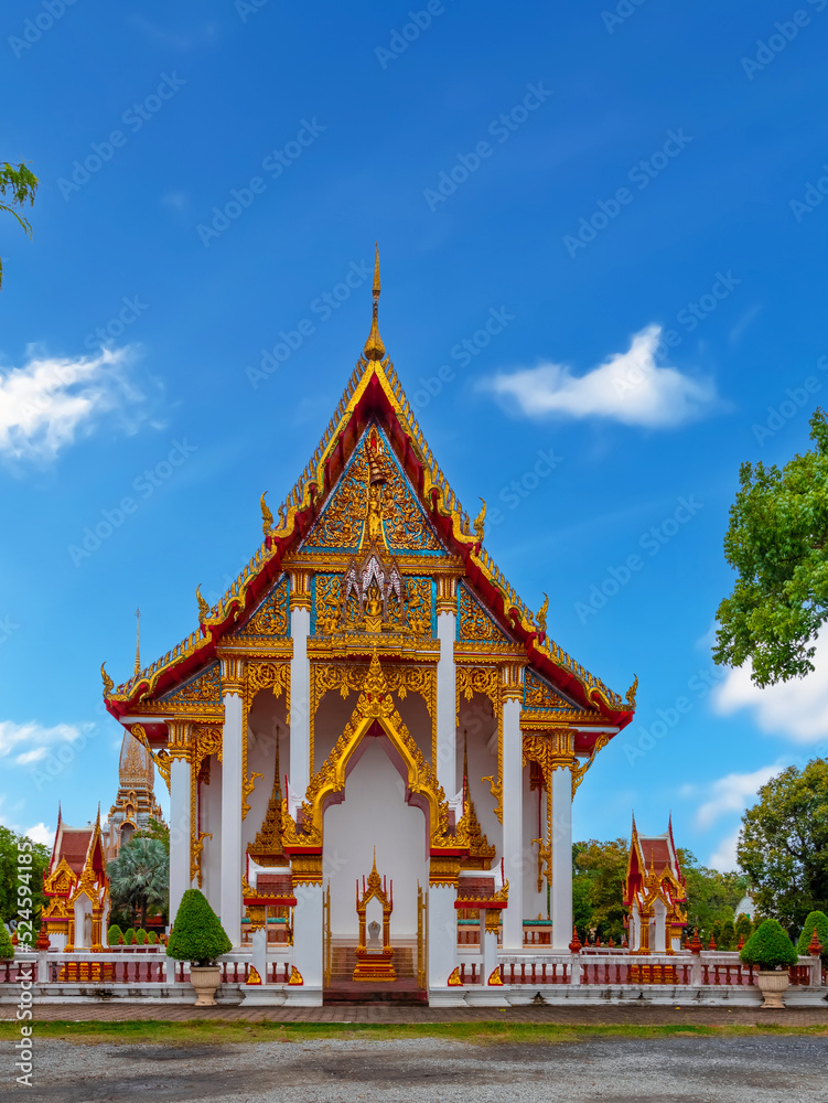 Beautiful Wat Chalong Buddhist temples in Phuket Thailand. Decorated in beautiful ornate colours of red and Gold and Blue. Lovely Sky