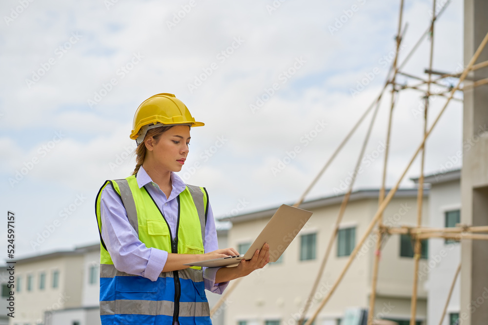 Single foreman female working with laptop on construction site Single foreman female working with laptop on construction site