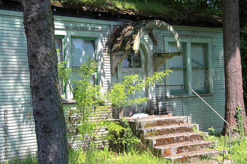 Abandoned broken haunted house displayed outdoors.