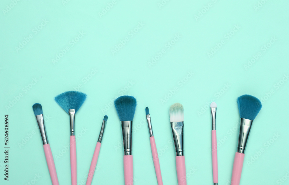 Makeup brushes on blue background. Beauty layout. Flat lay. Minimalism Makeup brushes on blue background. Beauty layout. Flat lay. Minimalism