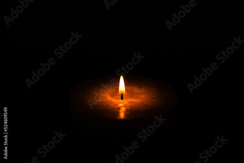 Funeral flaming candle isolated on black background