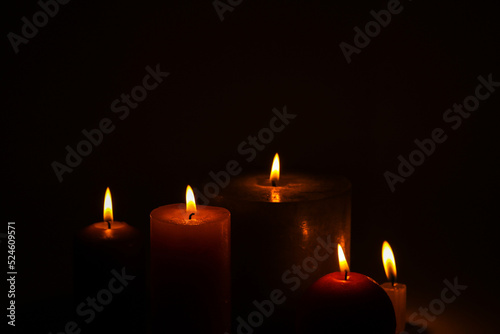 Flaming candles on a dark black background
