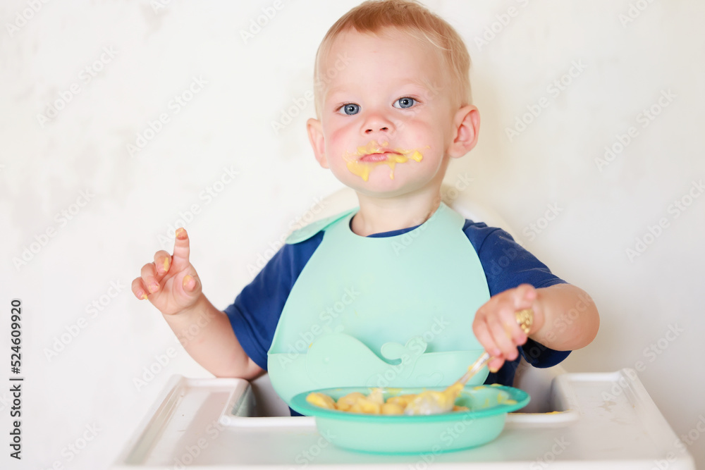 kid eats with a spoon and learns by himself kid eats with a spoon and learns by himself